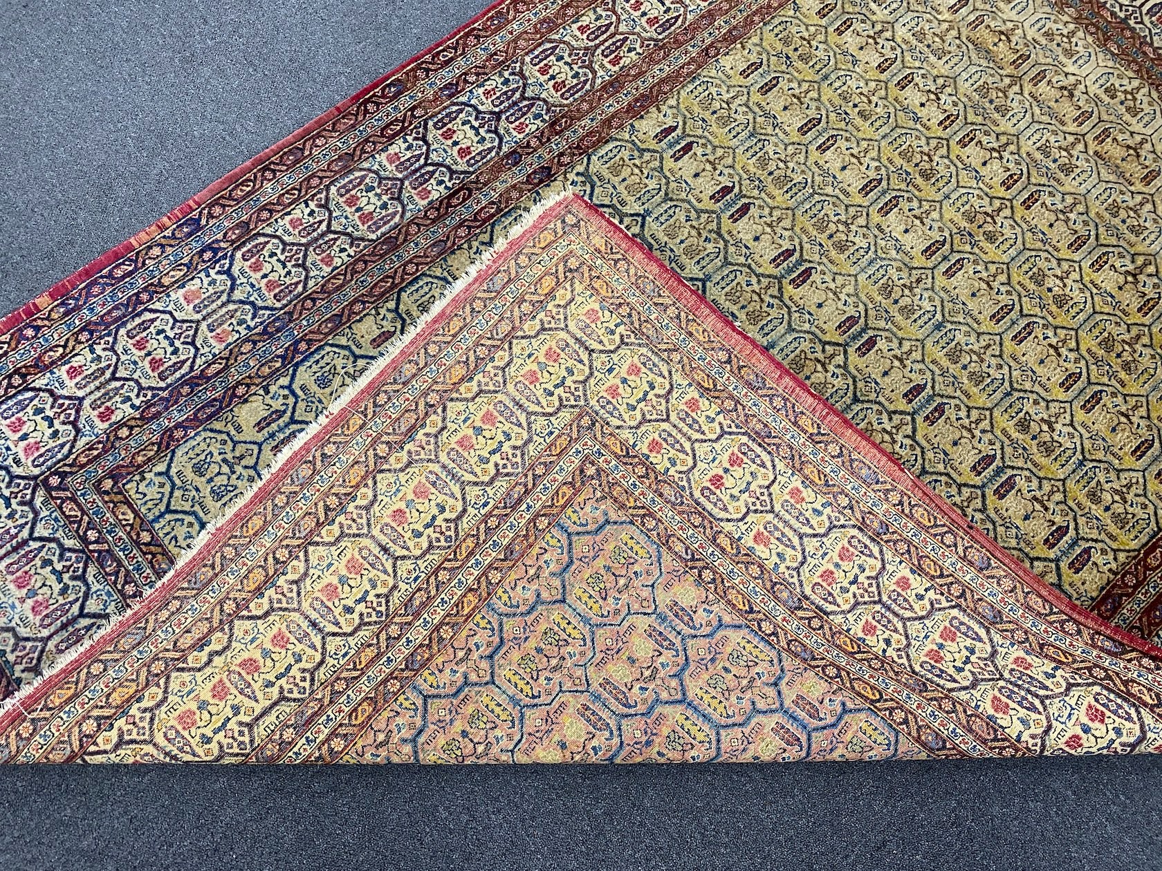 An antique North West Persian faded peach ground rug, 200 x 148cm